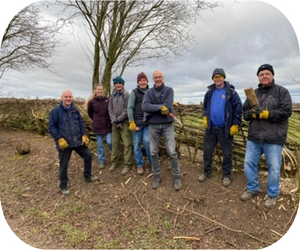 The volunteers beside their finished hedgerow. From left to right, Dave, Sara, Phill, Toby, Paul, Chris and Ian.