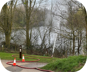 Water sprays from a pump into a lake