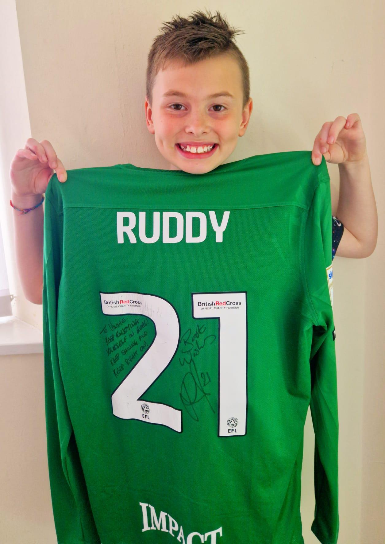 Vinnie holding a football shirt signed by Birmingham City goalkeeper, John Ruddy